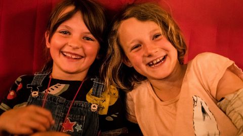 Zwei Mädchen im Kino der Zauberlaterne lachen in die Kamera