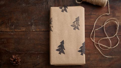 Weihnachtsgeschenk-Papier mit Tannenbäumen bedruckt