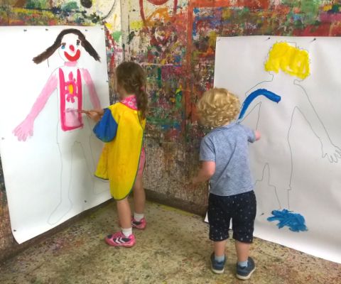 Chrüzacher in Dietikon Junge und Mädchen stehen vor grossem Papier und malen