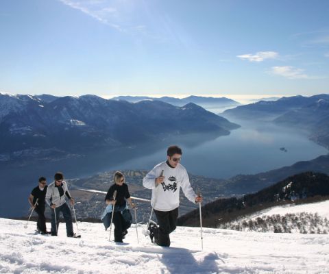 Eine Gruppe beim Schneeschuhwandern über dem Lago Maggiore