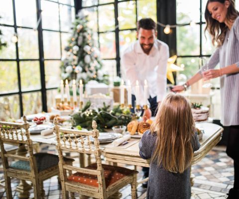 Una famiglia decora la tavola di Natale