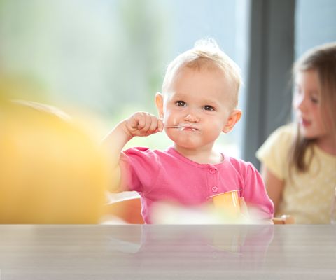 Un bambino mangia del quark alla frutta
