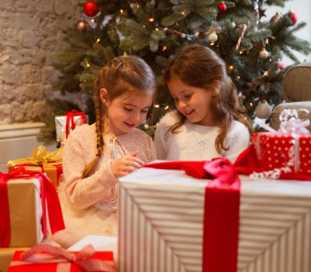Deux jeunes filles ouvrent leurs cadeaux de Noël