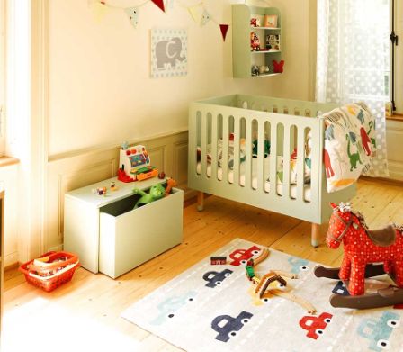Chambre d’enfant avec tapis de voiture et lit de bébé