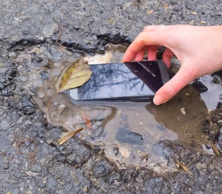 Un téléphone portable tombé dans une flaque est récupéré