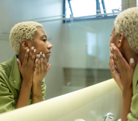 Une jeune femme se regardant dans un miroir.