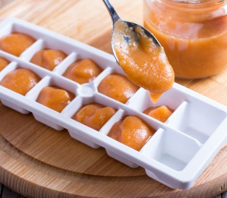 La pappa di carote viene versata nei cubetti di ghiaccio per essere congelata