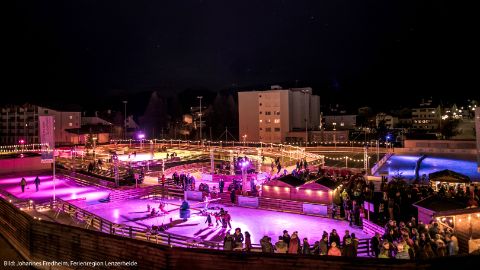 Stimmungsvoll beleuchtete Natureisbahn bei Nacht Stimmungsvoll beleuchtete Natureisbahn bei Nacht