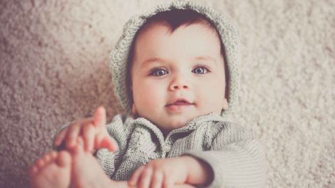 Bébé portant un bonnet et une veste tricotés Bébé portant un bonnet et une veste tricotés